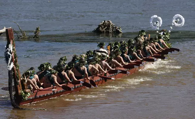 A waka, a traditional canoe, is paddled by warriors on the Waikato River as part of the funeral of New Zealand's Maori King, Kiingi Tuheitia Pootatau Te Wherowhero VII, in Ngaruawahia, New Zealand, Thursday, Sept. 5, 2024. (AP Photo/Alan Gibson)