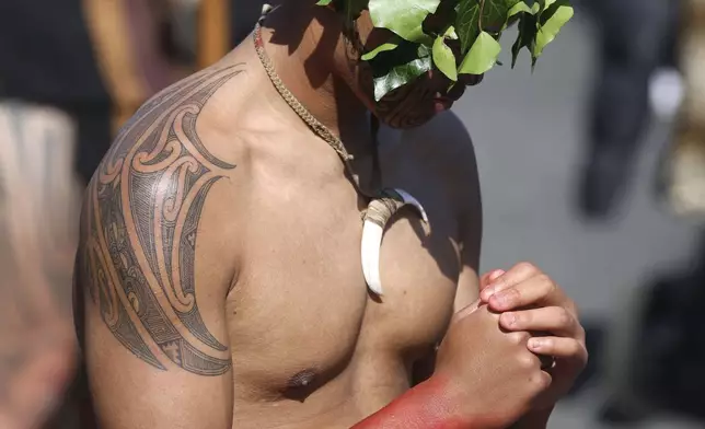 A warriors wait to receive the body of the Māori king, Kingi Tuheitia, next to the Waikato River where he will be carried up Taupiri Mountain for burial at Ngaruawahia, New Zealand, Thursday, Sept 6, 2024. (AP Photo/Alan Gibson)