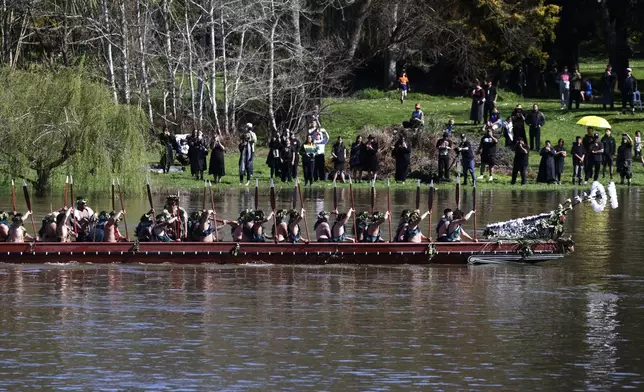 A waka, a traditional canoe, is paddled by warriors as part of the funeral of New Zealand's Maori King, Kiingi Tuheitia Pootatau Te Wherowhero VII, in Ngaruawahia, New Zealand, Thursday, Sept. 5, 2024. (AP Photo/Alan Gibson)