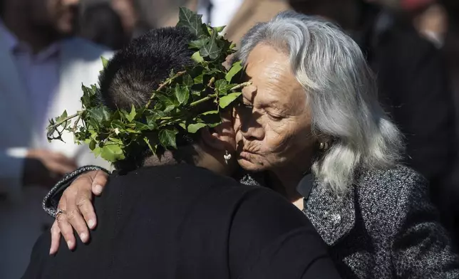 Mourners react outside Turangawaewae marae for the funeral of New Zealand's Māori King, Kiingi Tuheitia Pootatau Te Wherowhero VII, Thursday, Sept. 5, 2024, in Ngaruawahia, New Zealand. (AP Photo/Alan Gibson)