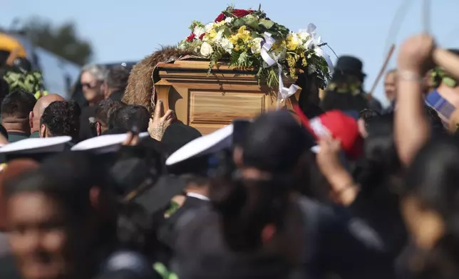 The coffin with the body of New Zealand's Maori King, Kiingi Tuheitia Pootatau Te Wherowhero VII, is carried up Taupiri Mountain for burial in Ngaruawahia, New Zealand, Thursday, Sept. 5, 2024. (AP Photo/Alan Gibson)