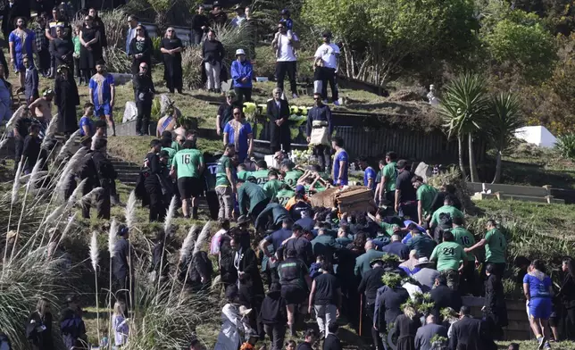 The coffin with the body of New Zealand's Maori King, Kiingi Tuheitia Pootatau Te Wherowhero VII, is carried up Taupiri Mountain for burial in Ngaruawahia, New Zealand, Thursday, Sept. 5, 2024. (AP Photo/Alan Gibson)