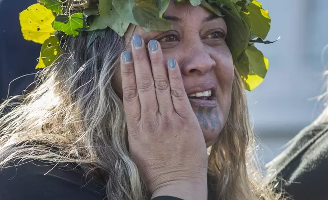 A mourner reacts outside Turangawaewae Marae for the funeral of New Zealand's Māori King, Kiingi Tuheitia Pootatau Te Wherowhero VII, in Ngaruawahia, New Zealand, Thursday, Sept 5, 2024. (AP Photo/Alan Gibson)