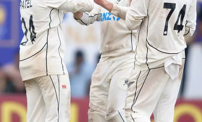 New Zealand's Ajaz Patel, left, celebrates with teammates the wicket of Sri Lanka's Kamindu Mendis on the first day of the first cricket test match between New Zealand and Sri Lanka in Galle, Sri Lanka, Wednesday, Sept. 18, 2024. (AP Photo/Viraj Kothalawala)