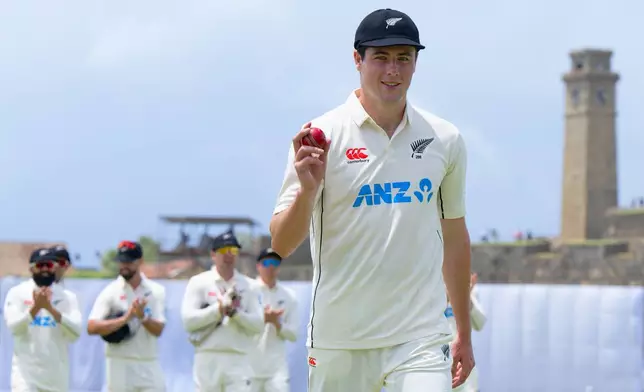 New Zealand's William O'Rourke shows the ball in his hand as he celebrates his 5-wicket haul at the end of the Sri Lanka innings on the second day of the first cricket test match between New Zealand and Sri Lanka in Galle, Sri Lanka, Thursday, Sept. 19, 2024. (AP Photo/Viraj Kothalawala)