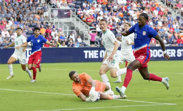 New Zealand goalkeeper Max Crocombe (1) makes a save against United States forward Haji Wright (19) during the first half of a friendly soccer match, Tuesday, Sept. 10, 2024, in Cincinnati. (AP Photo/Jeff Dean)