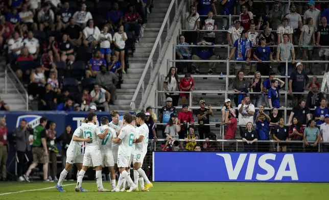 New Zealand's Ben Waine (18) celebrates with teammates after scoring during the second half of a friendly soccer match against the United States, Tuesday, Sept. 10, 2024, in Cincinnati. (AP Photo/Jeff Dean)