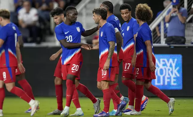 United States' Christian Pulisic (10) celebrates with teammates after scoring during the second half of a friendly soccer match against New Zealand, Tuesday, Sept. 10, 2024, in Cincinnati. (AP Photo/Jeff Dean)