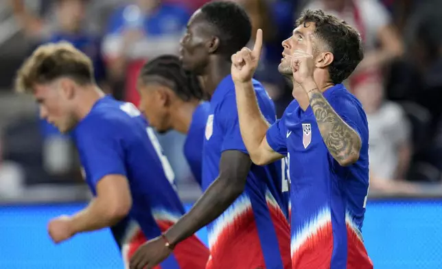 United States' Christian Pulisic, right, celebrates with teammates after scoring during the second half of a friendly soccer match against New Zealand, Tuesday, Sept. 10, 2024, in Cincinnati. (AP Photo/Jeff Dean)