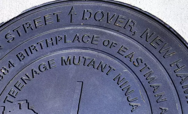 A city manhole cover, noting the Dover, New Hampshire birthplace of the Teenage Mutant Ninja Turtles, is seen at the outside the property, Thursday, Sept. 5, 2024, in Dover. I (AP Photo/Charles Krupa)