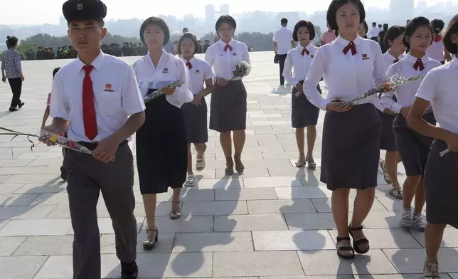 Pyongyang citizens pay respect to the statues of their late leaders Kim Il Sung and Kim Jong Il on Mansu Hill on the occasion of the country's 76th founding anniversary in Pyongyang, North Korea Monday, Sept. 9, 2024. (AP Photo/Jon Chol Jin)