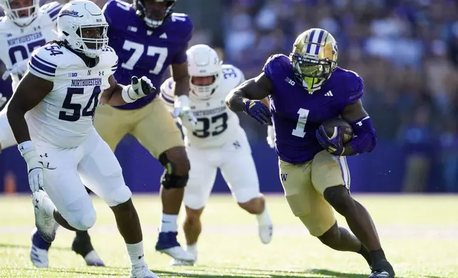 Washington running back Jonah Coleman (1) runs the football against Northwestern defensive lineman Tyler Gant (54) during the first half of an NCAA college football game Saturday, Sept. 21, 2024, in Seattle. (AP Photo/Lindsey Wasson)