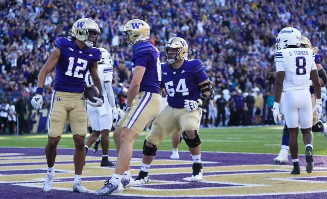 Washington wide receiver Denzel Boston (12) celebrates his touchdown with tight end Decker DeGraaf, front right, during the first half of an NCAA college football game against Northwestern, Saturday, Sept. 21, 2024, in Seattle. (AP Photo/Lindsey Wasson)