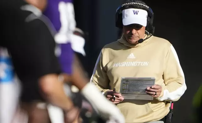 Washington head coach Jedd Fisch walks on the sideline during the first half of an NCAA college football game against Northwestern, Saturday, Sept. 21, 2024, in Seattle. (AP Photo/Lindsey Wasson)