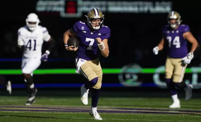 Washington quarterback Will Rogers runs the football for a first down against Northwestern during the first half of an NCAA college football game Saturday, Sept. 21, 2024, in Seattle. (AP Photo/Lindsey Wasson)