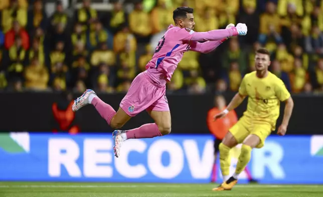 Porto goalkeeper Diogo Costa is airborne during the Europa League opening phase soccer match between Bodø/Glimt and Porto, at the Aspmyra stadium, in Bodo, Norway, Wednesday, Sept. 25, 2024. (Mats Torbergsen/NTB Scanpix via AP)
