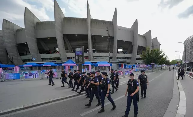 FILE - Police clear the streets outside the stadium ahead of the men's group D match between Israel and Mali at the Parc des Princes during the 2024 Summer Olympics, July 24, 2024, in Paris, France. (AP Photo/Rebecca Blackwell, File )