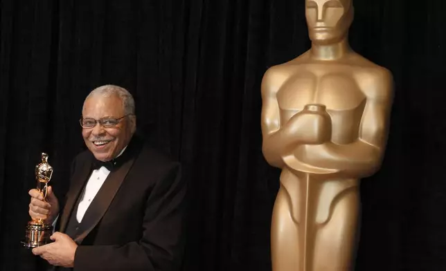 FILE - James Earl Jones poses with his honorary Oscar at the 84th Academy Awards on Sunday, Feb. 26, 2012, in the Hollywood section of Los Angeles. Jones, who overcame racial prejudice and a severe stutter to become a celebrated icon of stage and screen has died at age 93, Monday, Sept. 9, 2024. (AP Photo/Chris Carlson, File)