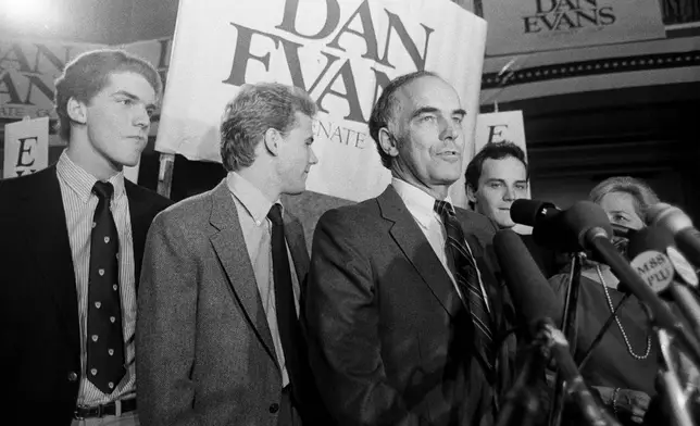 Sen. Dan Evans stands with his three sons, from left, Mark, Bruce and Dan Jr., after he won the election for Washington's senate seat in Seattle, Nov. 8, 1983. (AP Photo/Barry Sweet, File)