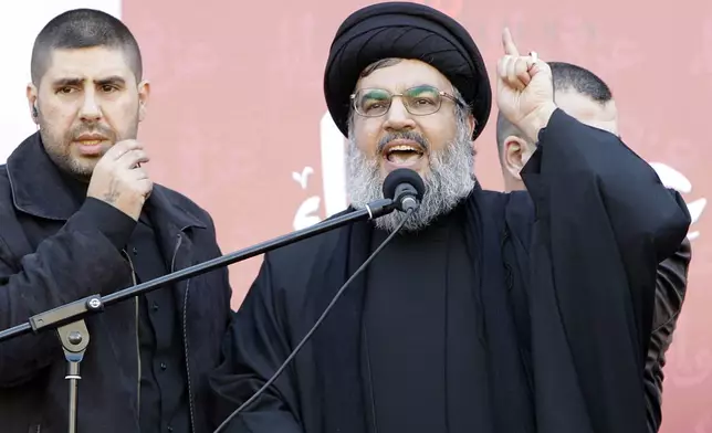 FILE - Hezbollah leader Hassan Nasrallah speaks to the crowd in a rare public appearance during a rally to mark the Muslim holy day of Ashoura, in Beirut's southern suburbs, Tuesday Dec. 6, 2011. (AP Photo/Bilal Hussein, File)