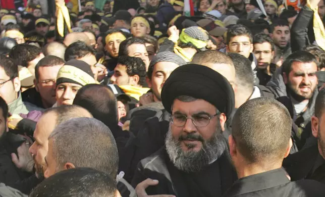 FILE - Hezbollah leader Hassan Nasrallah, center, walks among crowds of supporters during a commemoration in Beirut's southern suburbs, Saturday, on Jan. 19, 2008. (AP Photo/Hussein Malla, File)