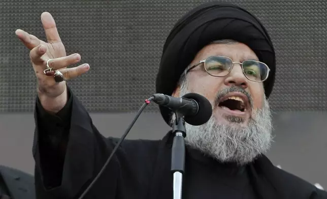 FILE - Hezbollah leader Sheik Hassan Nasrallah, speaks to the crowd in a rare public appearance during Ashura, that marks the death of Shiite Islam's Imam Hussein, in the suburbs of Beirut, Thursday, Nov. 14, 2013. (AP Photo/Bilal Hussein, File)