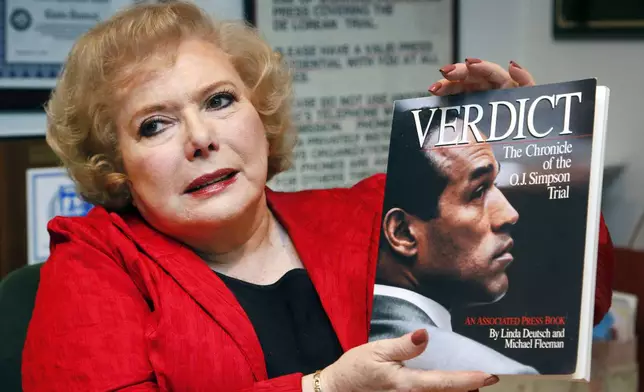 FILE - Associated Press special correspondent Linda Deutsch holds a copy of her book, "Verdict, The Chronicle of the O.J. Simpson Trial," at her home in Los Angeles, Dec. 11, 2014. (AP Photo/Nick Ut, File)