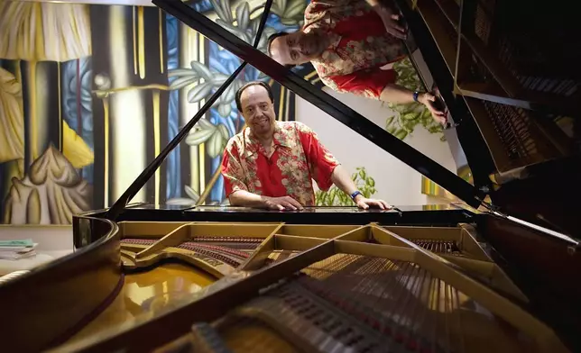 FILE - Bossa Nova piano maestro Sergio Mendes sits for a portrait at his home in Woodland Hills, Calif., on Feb. 7, 2006. (AP Photo/Damian Dovarganes, File)