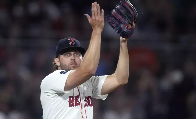 Boston Red Sox pitcher Kutter Crawford applauds after a fly out catch by outfielder Wilyer Abreu during the sixth inning of a baseball game against the Baltimore Orioles at Fenway Park, Tuesday, Sept. 10, 2024, in Boston. (AP Photo/Charles Krupa)