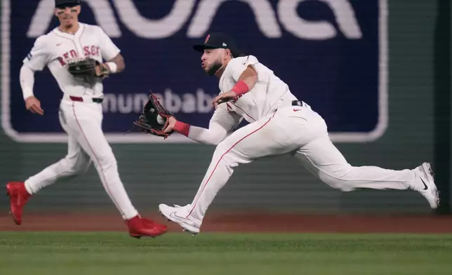 Boston Red Sox outfielder Wilyer Abreu, right, makes the catch on a fly out by Baltimore Orioles' Jackson Holliday during the sixth inning of a baseball game at Fenway Park, Tuesday, Sept. 10, 2024, in Boston. At left is Red Sox outfielder Jarren Duran. (AP Photo/Charles Krupa)