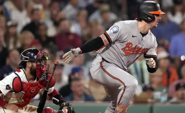 Baltimore Orioles' Adley Rutschman watches his two-RBI single during the seventh inning of a baseball game at Fenway Park, Tuesday, Sept. 10, 2024, in Boston. At left is Boston Red Sox catcher Connor Wong. (AP Photo/Charles Krupa)