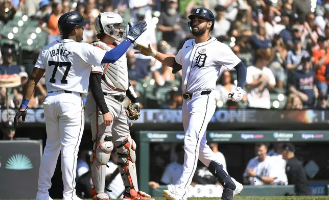 Detroit Tigers' Riley Greene, right, is congratulated by Andy Ibáñez after hitting a two-run home run off Baltimore Orioles starting pitcher Cade Povich in the third inning of a baseball game, Sunday, Sept. 15, 2024, in Detroit. (AP Photo/Jose Juarez)