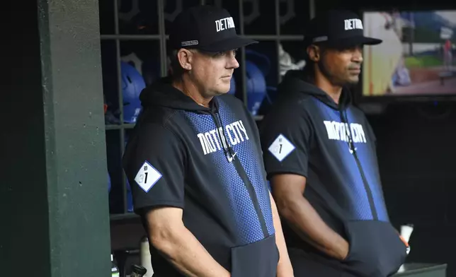 Detroit Tigers manager A.J. Hinch, left, and bench coach George Lombard, right, watch from the dugout before a baseball game against the Baltimore Orioles, Friday, Sept. 13, 2024, in Detroit. (AP Photo/Jose Juarez)