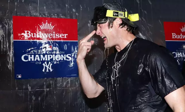 New York Yankees' Gerrit Cole celebrates with teammates after clinching the American League East title in a baseball game against Baltimore Orioles, Thursday, Sept. 26, 2024, in New York. (AP Photo/Noah K. Murray)