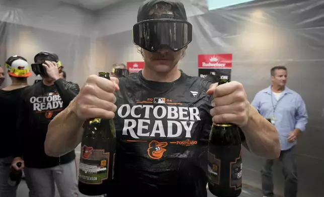 Baltimore Orioles' Gunnar Henderson celebrates after the team clinched a playoff berth by defeating the New York Yankees in baseball game, Tuesday, Sept. 24, 2024, in New York. (AP Photo/Bryan Woolston)