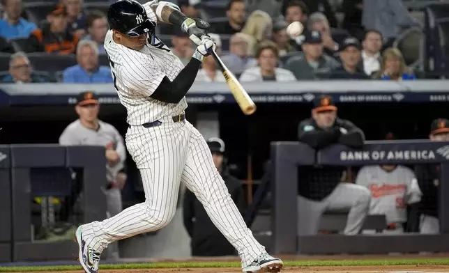 New York Yankees' Gleyber Torres (25) hits a single during the first inning of a baseball game against the Baltimore Orioles, Tuesday, Sept. 24, 2024, in New York. (AP Photo/Bryan Woolston)