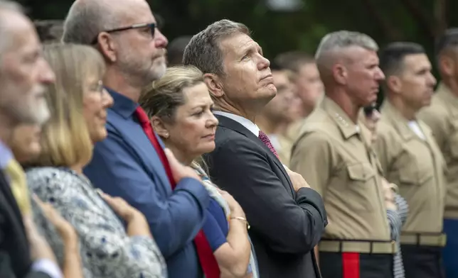 Bart Collart, the father of Cpl. Spencer Collart, looks up during the playing of the National Anthem during a Navy and Marine Corps medal awarding ceremony for his son on Monday, Sept. 16, 2024 in Washington. (AP Photo/Kevin Wolf)