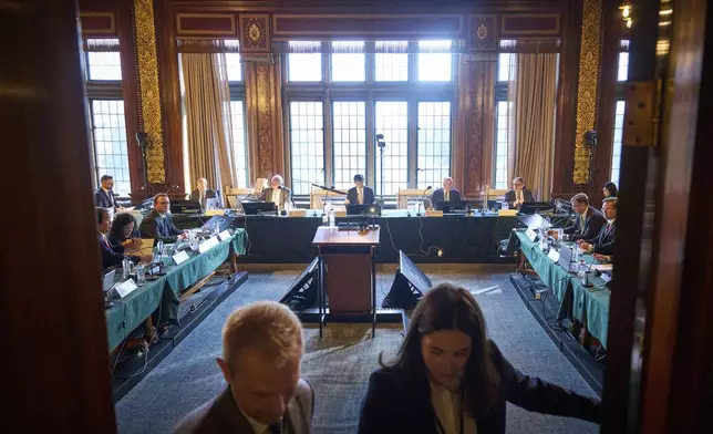 The delegations of Ukraine and Russia attend the start of PCA Case between Ukraine and the Russian Federation in the Netherlands, Monday, Sept. 23, 2024. (AP Photo/Phil Nijhuis)