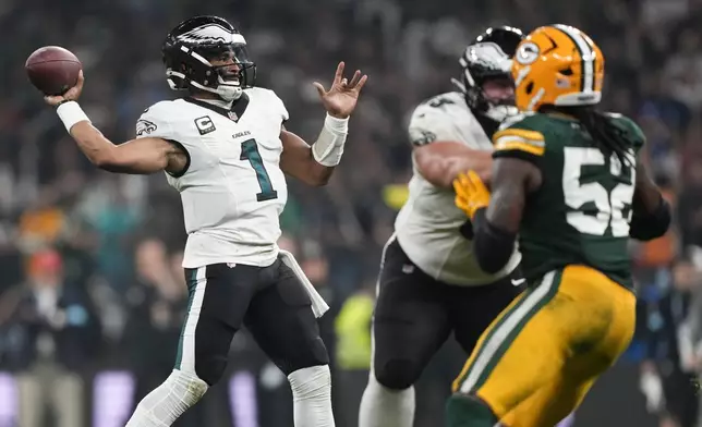 Philadelphia Eagles quarterback Jalen Hurts (1) passes against the Green Bay Packers during the first half of an NFL football game, Friday, Sept. 6, 2024, at the Neo Quimica Arena in Sao Paulo. (AP Photo/Doug Benc)