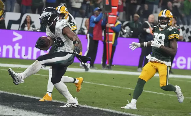 Philadelphia Eagles running back Saquon Barkley (26) celebrates after scoring against the Green Bay Packers during the first half of an NFL football game, Friday, Sept. 6, 2024, at the Neo Quimica Arena in Sao Paulo. (AP Photo/Fernando Llano)