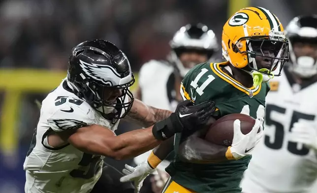 Green Bay Packers wide receiver Jayden Reed (11) breaks away from Philadelphia Eagles linebacker Zack Baun (53) during the first half of an NFL football game, Friday, Sept. 6, 2024, at the Neo Quimica Arena in Sao Paulo. (AP Photo/Andre Penner)