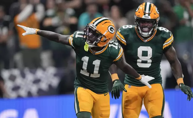 Green Bay Packers wide receiver Jayden Reed (11) celebrates after scoring against the Philadelphia Eagles during the first half of an NFL football game, Friday, Sept. 6, 2024, at the Neo Quimica Arena in Sao Paulo. (AP Photo/Doug Benc)