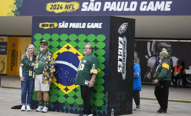 Fans pose for a picture before an NFL football game between the Philadelphia Eagles and the Green Bay Packers on Friday, Sept. 6, 2024, at the Neo Quimica Arena in Sao Paulo. (AP Photo/Andre Penner)