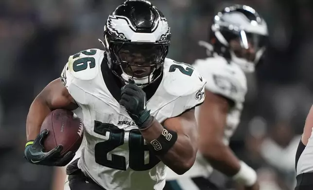 Philadelphia Eagles running back Saquon Barkley (26) runs for a touchdown against the Green Bay Packers during the first half of an NFL football game, Friday, Sept. 6, 2024, at the Neo Quimica Arena in Sao Paulo.(AP Photo/Doug Benc)