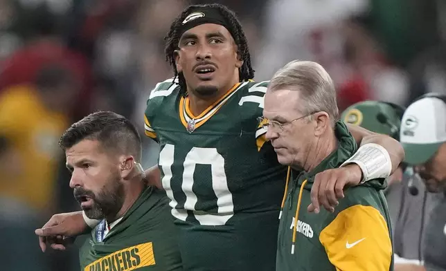 Green Bay Packers quarterback Jordan Love (10) in helped off the field after getting hurt during the second half of an NFL football game against the Philadelphia Eagles, Saturday, Sept. 7, 2024, at the Neo Quimica Arena in Sao Paulo. (AP Photo/Doug Benc)