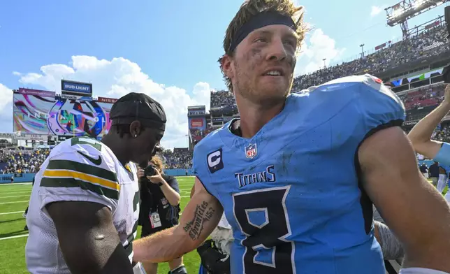 Green Bay Packers' Malik Willis talks to Tennessee Titans' Will Levis after an NFL football game Sunday, Sept. 22, 2024, in Nashville, Tenn. (AP Photo/John Amis)