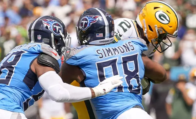 Green Bay Packers' Malik Willis is sacked by Tennessee Titans' Jeffery Simmons during the first half of an NFL football game Sunday, Sept. 22, 2024, in Nashville, Tenn. (AP Photo/George Walker IV)