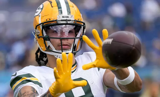 Green Bay Packers' Christian Watson warms up before an NFL football game against the Tennessee Titans Sunday, Sept. 22, 2024, in Nashville, Tenn. (AP Photo/George Walker IV)