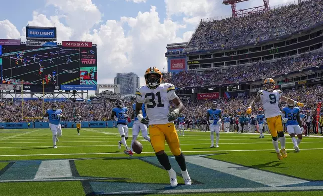 Green Bay Packers' Emanuel Wilson celebrates his touchdown during the second half of an NFL football game against the Tennessee Titans Sunday, Sept. 22, 2024, in Nashville, Tenn. (AP Photo/George Walker IV)