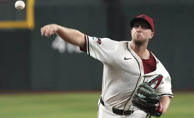 Arizona Diamondbacks pitcher Merrill Kelly throws against the San Diego Padres in the first inning during a baseball game, Friday, Sept. 27, 2024, in Phoenix. (AP Photo/Rick Scuteri)